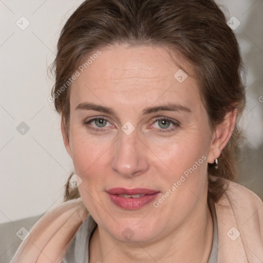 Joyful white adult female with medium  brown hair and blue eyes