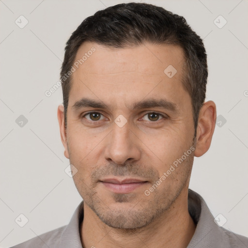 Joyful white adult male with short  brown hair and brown eyes