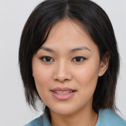 Joyful asian young-adult female with medium  brown hair and brown eyes