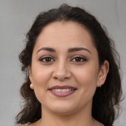 Joyful white adult female with medium  brown hair and brown eyes