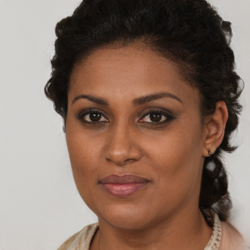 Joyful black young-adult female with medium  brown hair and brown eyes