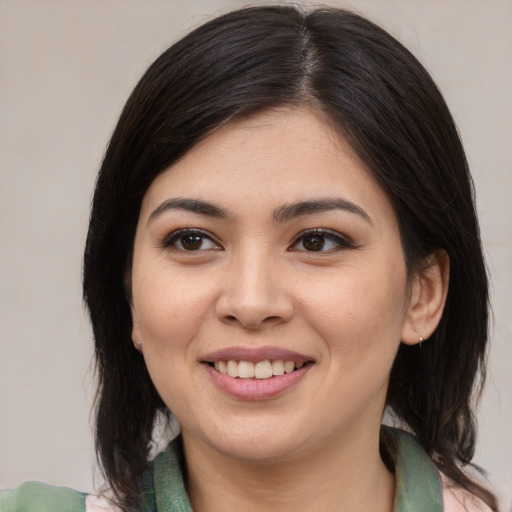 Joyful asian young-adult female with medium  brown hair and brown eyes