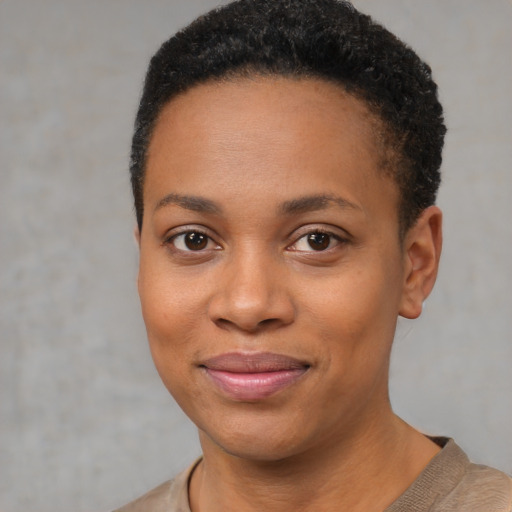 Joyful black young-adult female with short  brown hair and brown eyes