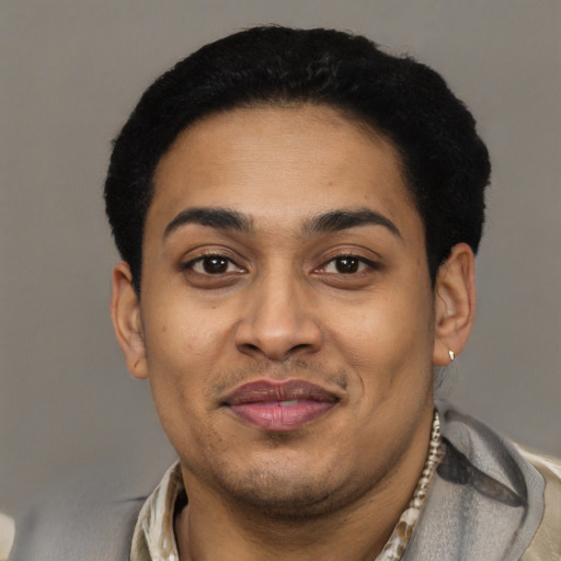 Joyful latino young-adult male with short  black hair and brown eyes