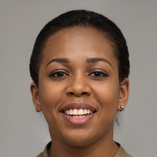 Joyful black young-adult female with short  black hair and brown eyes