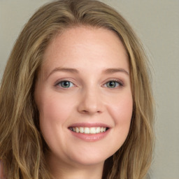 Joyful white young-adult female with long  brown hair and green eyes