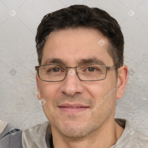 Joyful white adult male with short  black hair and brown eyes