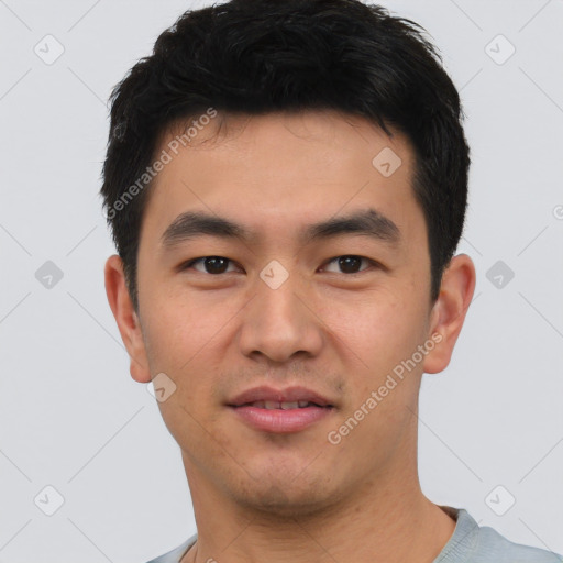 Joyful asian young-adult male with short  black hair and brown eyes