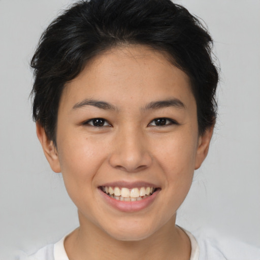 Joyful asian young-adult female with short  brown hair and brown eyes