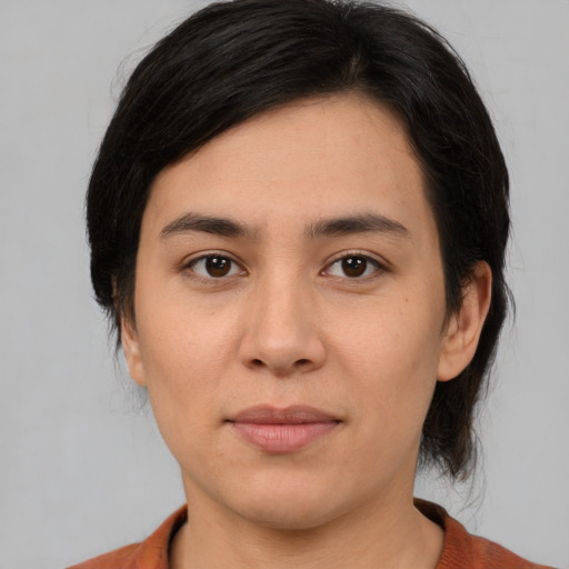 Joyful latino young-adult female with medium  brown hair and brown eyes