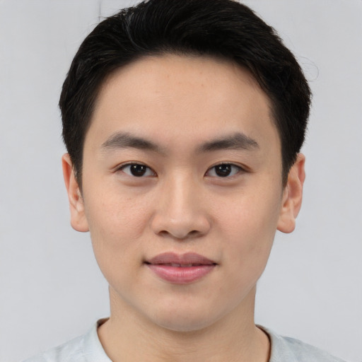 Joyful asian young-adult male with short  brown hair and brown eyes