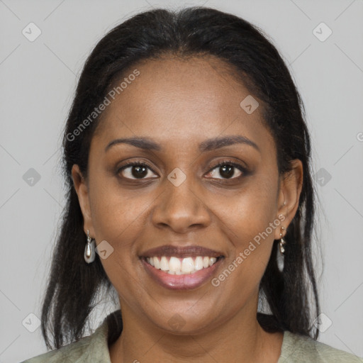 Joyful black young-adult female with long  brown hair and brown eyes