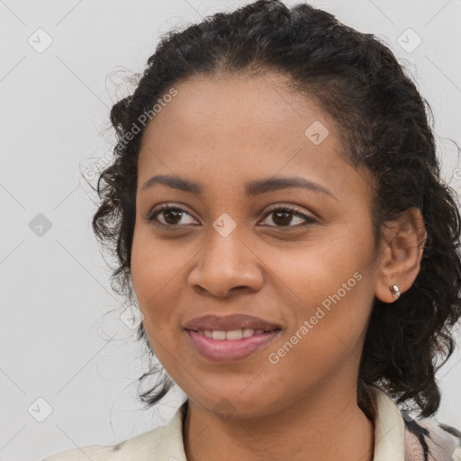 Joyful black young-adult female with long  brown hair and brown eyes