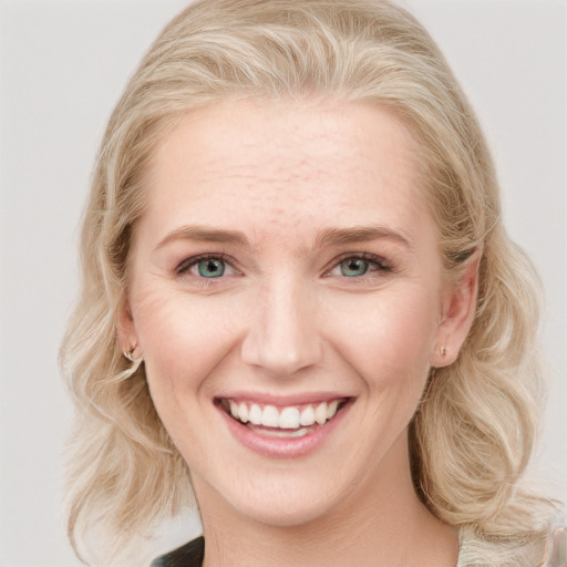 Joyful white young-adult female with long  blond hair and blue eyes