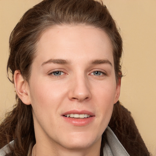 Joyful white young-adult female with long  brown hair and grey eyes