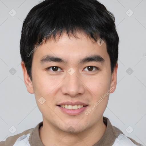 Joyful asian young-adult male with short  brown hair and brown eyes