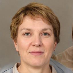 Joyful white adult female with short  brown hair and grey eyes