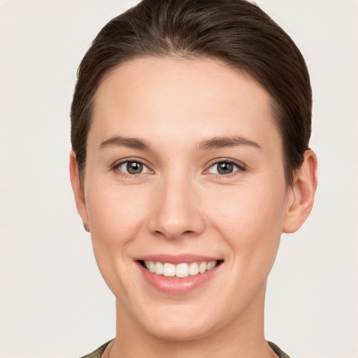 Joyful white young-adult female with short  brown hair and brown eyes