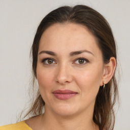 Joyful white young-adult female with medium  brown hair and brown eyes