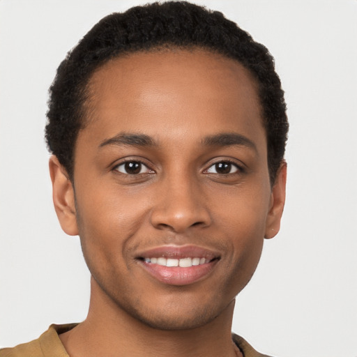 Joyful black young-adult male with short  brown hair and brown eyes