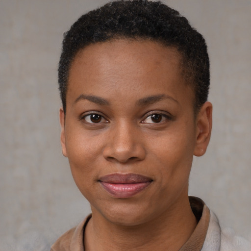 Joyful black young-adult female with short  brown hair and brown eyes