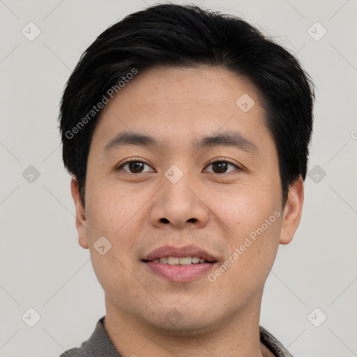 Joyful asian young-adult male with short  black hair and brown eyes