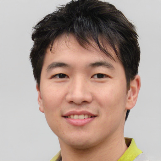 Joyful asian young-adult male with short  brown hair and brown eyes