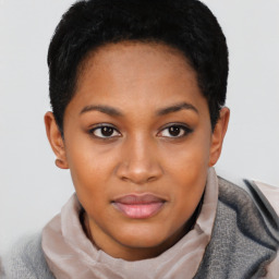 Joyful black young-adult female with short  black hair and brown eyes