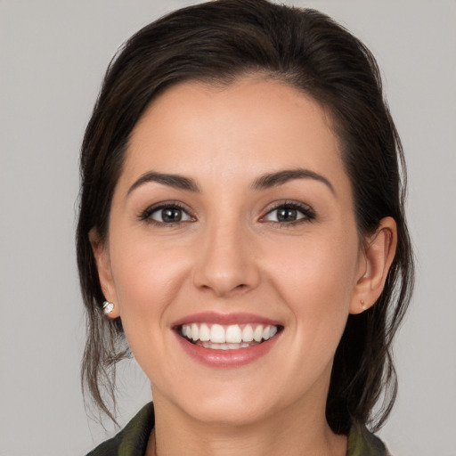 Joyful white young-adult female with medium  brown hair and brown eyes