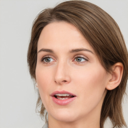 Joyful white young-adult female with medium  brown hair and green eyes