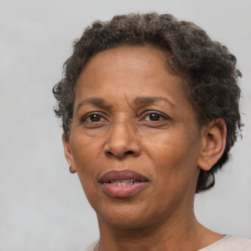 Joyful black adult female with short  brown hair and brown eyes