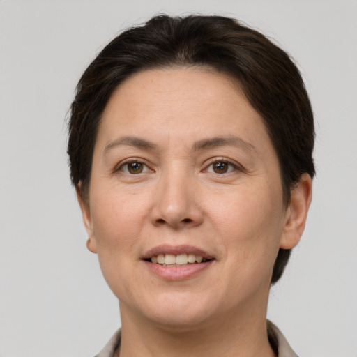 Joyful white adult female with short  brown hair and brown eyes