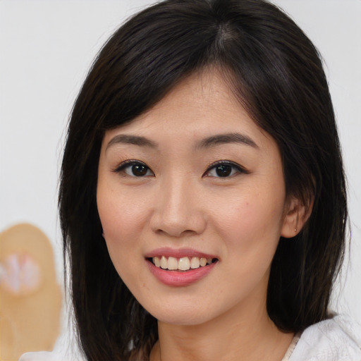 Joyful white young-adult female with medium  brown hair and brown eyes