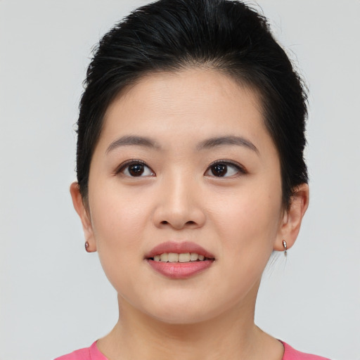 Joyful asian young-adult female with short  brown hair and brown eyes
