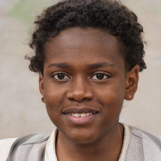Joyful black child male with short  brown hair and brown eyes