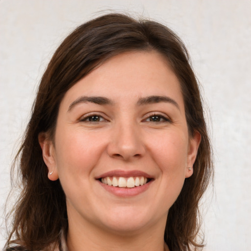 Joyful white young-adult female with medium  brown hair and brown eyes