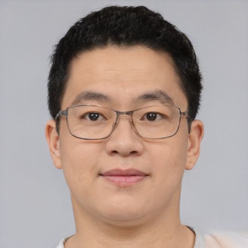 Joyful asian adult male with short  brown hair and brown eyes
