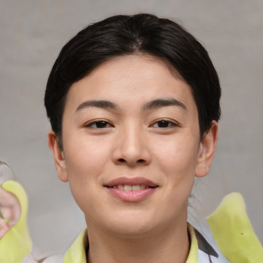 Joyful asian young-adult female with short  brown hair and brown eyes