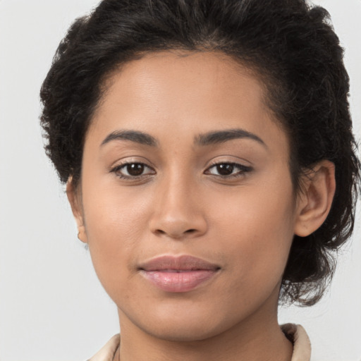 Joyful latino young-adult female with long  brown hair and brown eyes