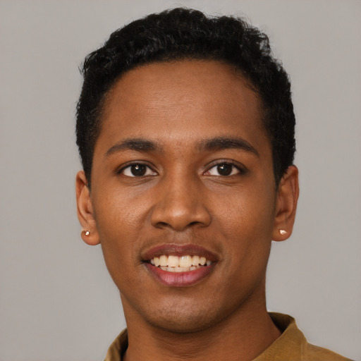 Joyful black young-adult male with short  black hair and brown eyes