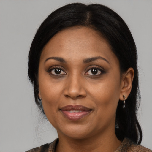 Joyful black adult female with medium  black hair and brown eyes