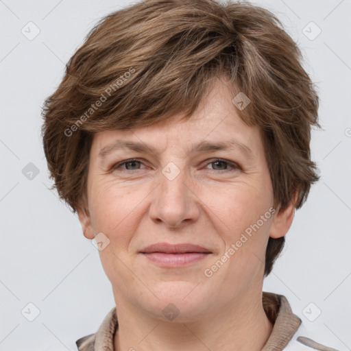 Joyful white adult female with short  brown hair and grey eyes