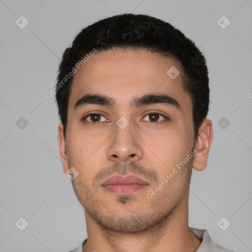 Neutral latino young-adult male with short  black hair and brown eyes