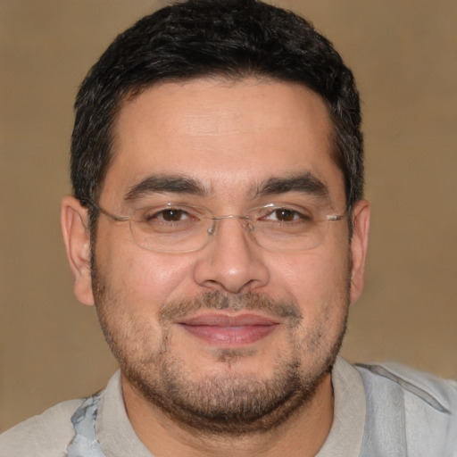 Joyful white adult male with short  black hair and brown eyes