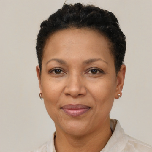 Joyful black adult female with short  brown hair and brown eyes