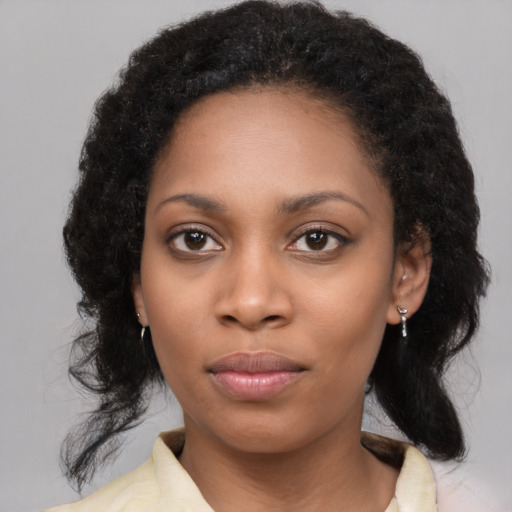 Joyful black young-adult female with medium  black hair and brown eyes