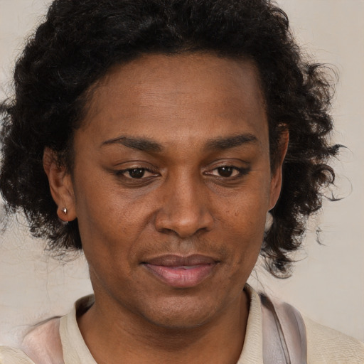 Joyful black adult female with medium  brown hair and brown eyes