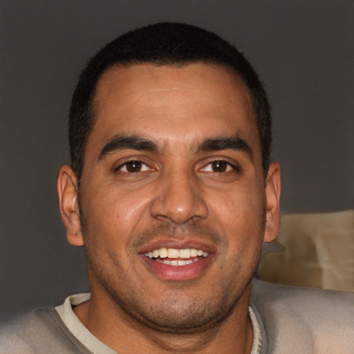 Joyful black young-adult male with short  brown hair and brown eyes