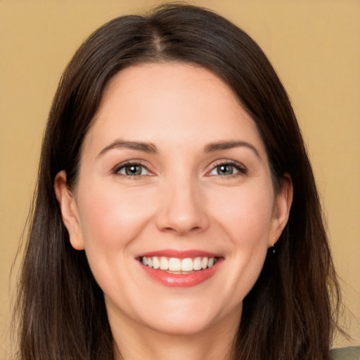 Joyful white young-adult female with long  brown hair and brown eyes