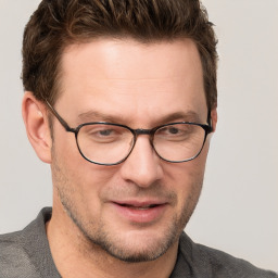 Joyful white adult male with short  brown hair and grey eyes